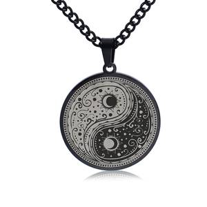 Detailed view of black titanium Tai Chi pendant with silver celestial engravings