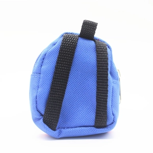 Detail view of mini blue canvas backpack keychain featuring silver zipper and black straps