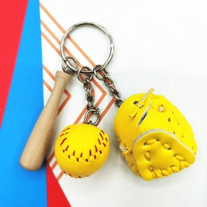 Detailed close-up of 3-in-1 baseball keychain with mini wooden bat and yellow leather glove