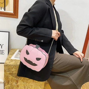 Pink pumpkin shaped crossbody bag with gold chain strap for Halloween fashion outfits