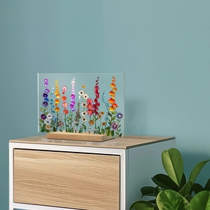 Floral acrylic desktop plaque with wood base displayed on a modern white cabinet