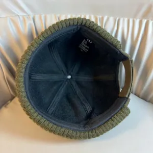 Army green knitted brimless docker hat with adjustable strap and warm black inner lining