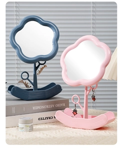 Close-up of flower-shaped desktop makeup mirrors with integrated jewelry organizers in blue and pink