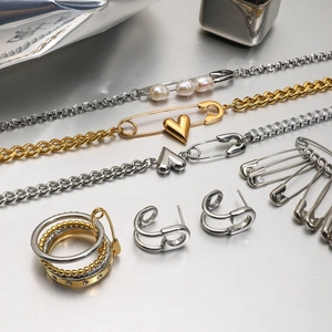 Safety pin jewelry set with gold and silver necklaces, earrings and pearls