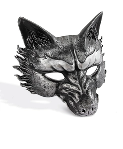 Detail of vintage wolf mask with silver metallic finish and intricate carved textures