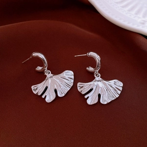 Detailed view of silver ginkgo leaf earrings with radial leaf texture and C-shaped ear hooks