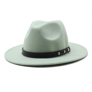 Detail of mint green wool fedora hat featuring black leather band and silver studs