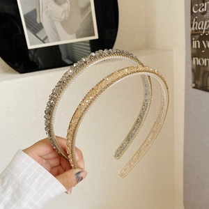 Close-up of sparkling crystal and pearl headbands in grey and champagne colors