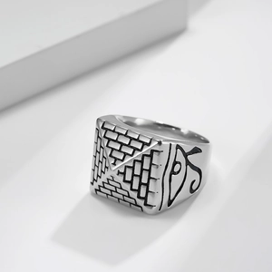 Vintage silver steel Egyptian ring featuring Horus eye and pyramid motifs on white background
