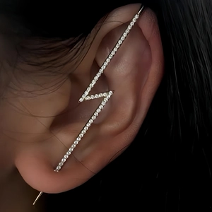 Macro shot of silver lightning-shaped ear crawler with sparkling cubic zirconia pavé