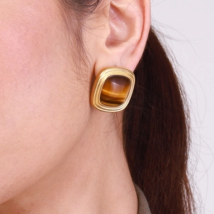 Luxurious gold-plated square tiger eye stone earrings worn as an elegant closeup view