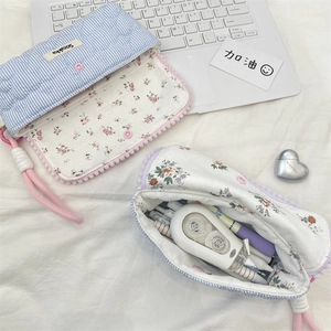 Inside view of floral quilted pencil case showing large capacity for pens and stationery