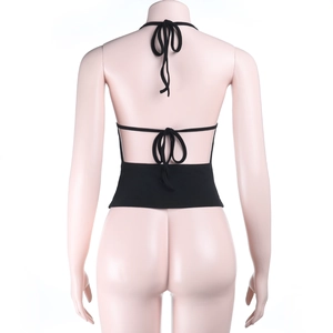 Detail of the backless halter design with tie-up straps on a black crop camisole top
