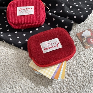 Plush corduroy and fleece mini coin pouches in red with zipper and label details