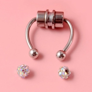 Detail of silver magnetic nose ring set with sparkling multicolored crystal ball studs