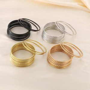 Close-up of twisted multi-layer titanium steel bracelets in four metallic colors