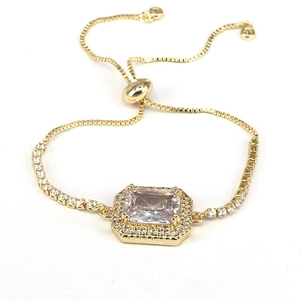 Detail view of gold luxury bracelet with large rectangular zircon and adjustable sliding clasp