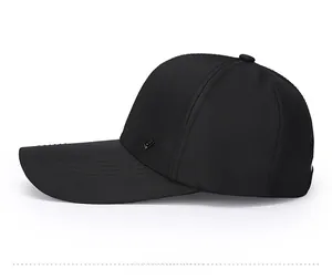 Side view of black baseball cap showing triangular metal logo and twill fabric texture