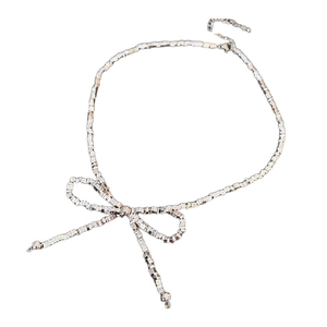 Silver bow pendant necklace with sparkling faceted elements on a clean white background