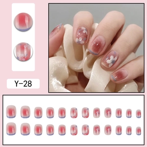 Detail view of Y-28 press-on nails featuring camellia floral patterns and red gradient art