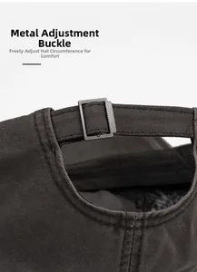 Detail of adjustable metal buckle and washed cotton twill fabric on charcoal baseball cap