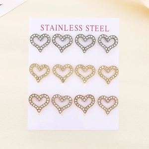 Three rows of heart-shaped stainless steel earrings with sparkling rhinestones on a card