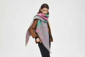 Detailed macro view of pink and green plaid scarf texture and soft fringe edges