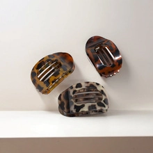 Close-up detail showing the texture of three retro leopard print acrylic hair clips