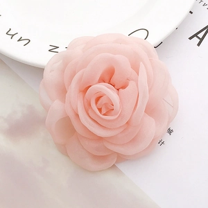 Detailed view of layered light pink chiffon rose flower accessory for DIY craft decor