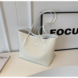 Detailed view of white woven tote bag showing fine texture and large capacity