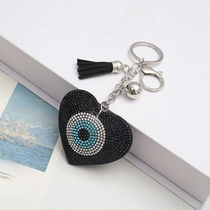 Sparkling black heart keychain with rhinestone evil eye motif and tassel accessory