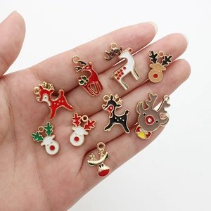Handheld view of ten colorful enamel Christmas reindeer pendants for jewelry making