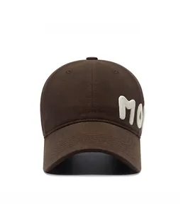 Detailed front view of brown cotton baseball cap with white MO towel embroidery