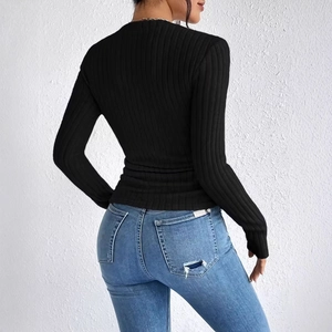 Close-up back view of a black ribbed knit long sleeve top with pearl bead details