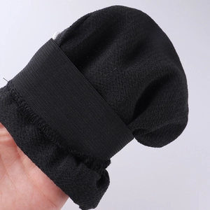 Exfoliating bath glove in black textured fabric with elastic wristband for deep cleaning