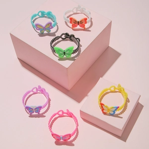 Set of 6 colorful silicone butterfly bracelets for kids on pink display stands