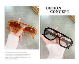 Detail view of double bridge geometric sunglasses in amber and black tortoise shell finish