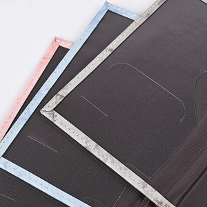 Macro detail of textured marble PU passport covers showing precise stitching and clear PVC slots