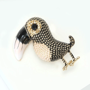 Detail view of a vintage toucan bird brooch with colorful enamel and sparkling gold accents
