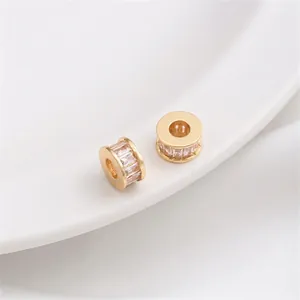 Detailed view of 14K gold plated wheel spacers with baguette-cut cubic zirconia inlays
