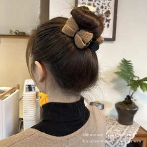 Brown plush bow hair claw clip for women's bun hairstyles in warm winter style