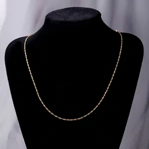 Elegant gold stainless steel twist chain necklace displayed on a black neck bust