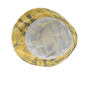 Detail view of cotton tie-dye bucket hat interior showing inner stitching and material label