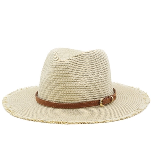 Beige straw sun hat with brown leather buckle strap and frayed edges for summer holidays