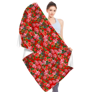 Detail view of microfiber beach towel featuring vibrant red peony and phoenix patterns