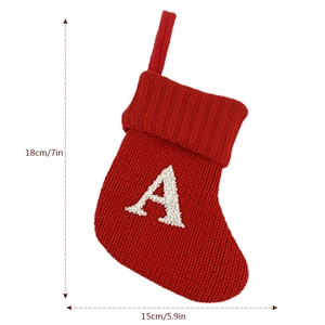 Detail of red knitted Christmas stocking with white letter A and size specifications