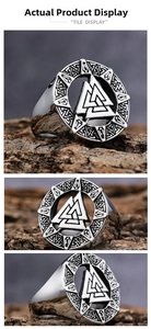 Macro detail of silver Valknut viking ring with engraved runes on rustic wood surface