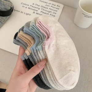 Close-up of low-cut cotton socks with embroidered bows and ribbed elastic cuffs