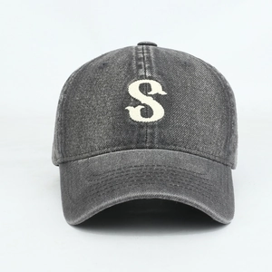 Detail of vintage washed denim baseball cap featuring white towel embroidery S letter