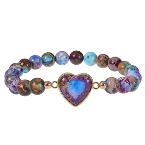 Close-up of bohemian 8mm stone beads with a gold-edged heart pendant on a white background